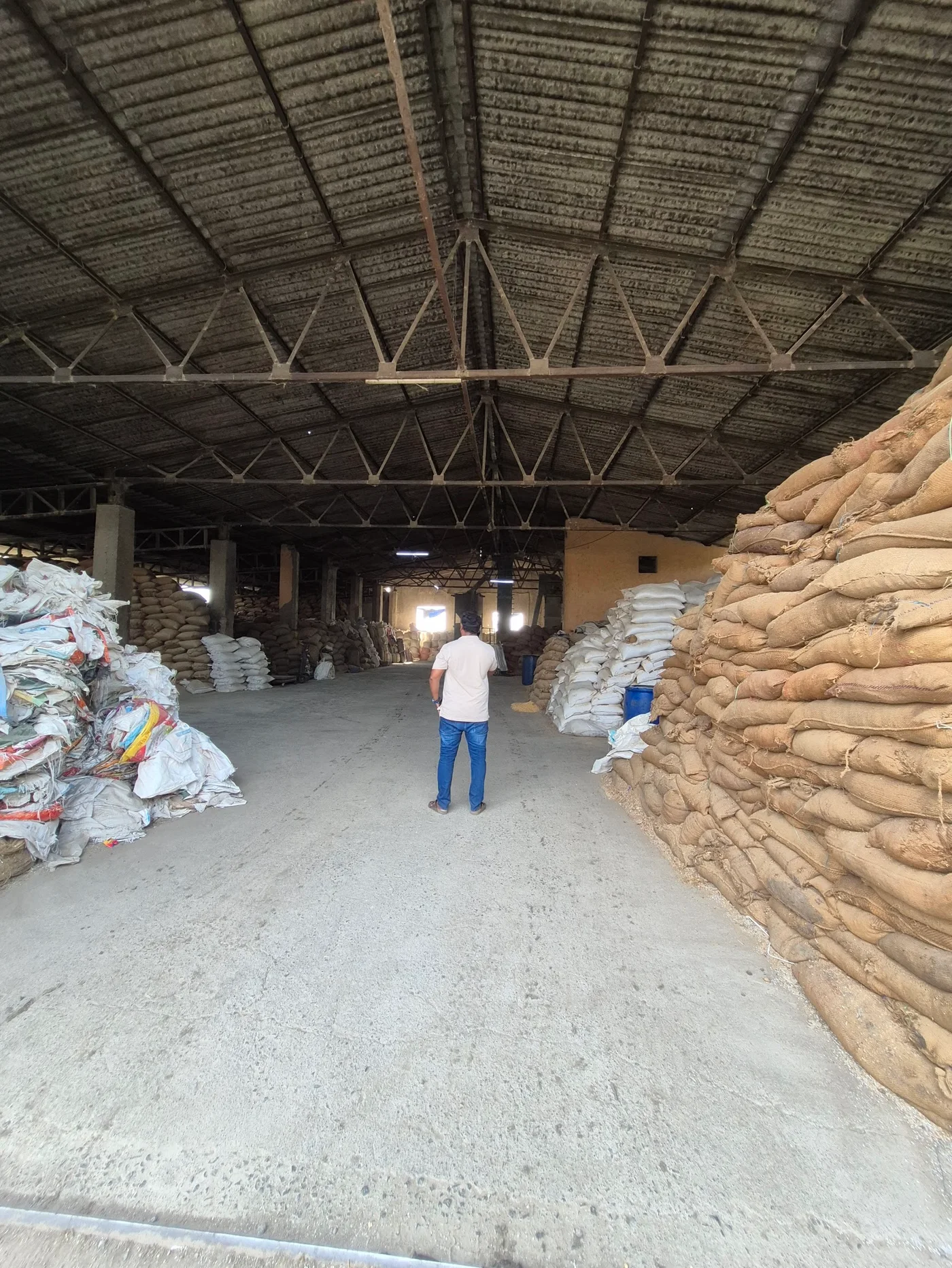 Wide interior view of the storage warehouse with stacked sacks